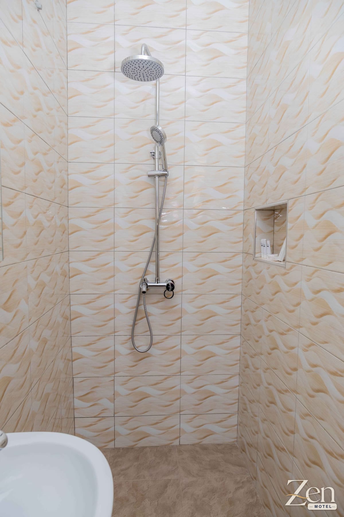 Walk-in rain shower with patterned wall tiles